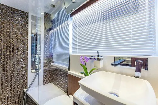  Yacht Photos Pics Luxurious bathroom in 2019 Galeon 640 Fly yacht with modern fixtures and mosaic tiles.