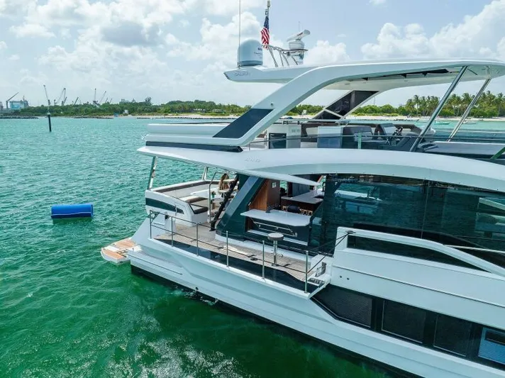  Yacht Photos Pics 2019 Galeon 640 Fly yacht on turquoise water, showcasing sleek design and spacious deck.