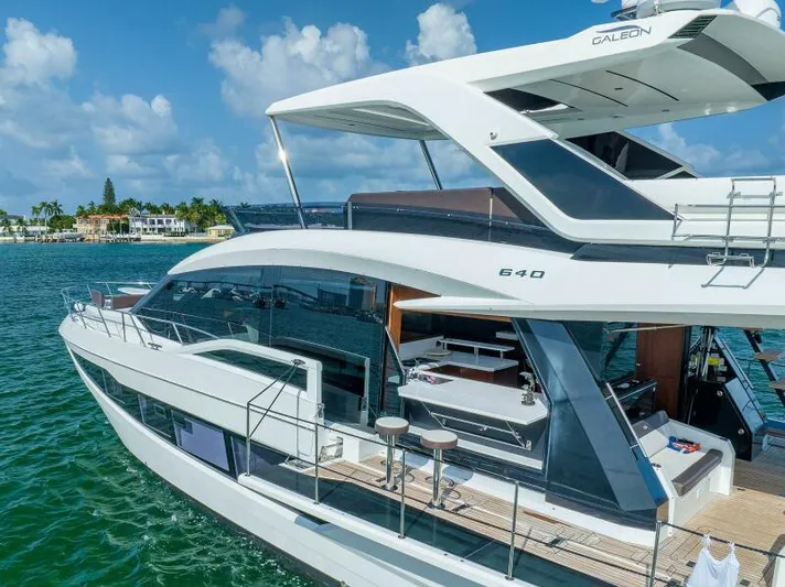  Yacht Photos Pics Luxurious 2019 Galeon 640 Fly yacht cruising on clear blue waters.