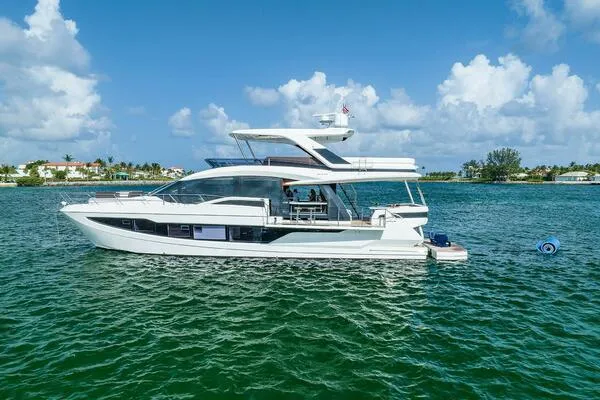  Yacht Photos Pics 2019 Galeon 640 Fly yacht cruising on a sunny day with blue skies and calm waters.