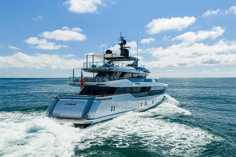 Neverland II Yacht Photos Pics Luxury Sanlorenzo 44 Alloy yacht cruising on open sea under clear blue sky, 2020 model.