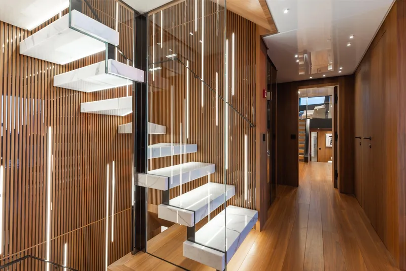 Neverland II Yacht Photos Pics Modern interior staircase on 2020 Sanlorenzo 44 Alloy yacht, featuring sleek wood and glass design.