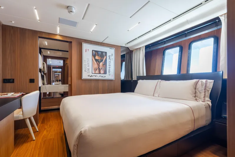 Neverland II Yacht Photos Pics Luxurious bedroom interior on 2020 Sanlorenzo 44 Alloy yacht, featuring elegant wood finishes.
