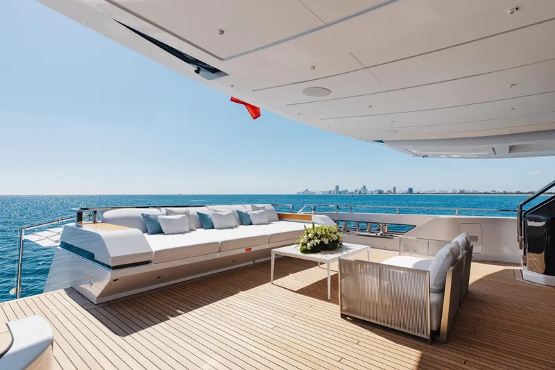 Neverland II Yacht Photos Pics Luxurious Sanlorenzo 44 Alloy yacht deck with elegant seating, ocean view, and city skyline, 2020 model.