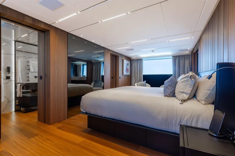 Neverland II Yacht Photos Pics Luxurious bedroom interior on 2020 Sanlorenzo 44 Alloy yacht, featuring modern design and wood accents.