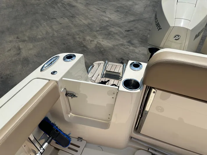  Yacht Photos Pics 2022 Scout 277 Dorado boat interior with storage compartment and Mercury outboard engine.