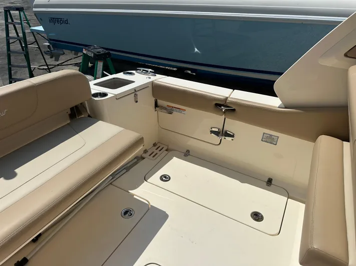  Yacht Photos Pics 2022 Scout 277 Dorado boat interior with beige seating and storage compartments.