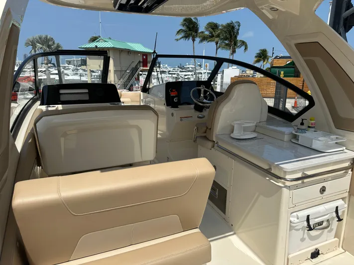  Yacht Photos Pics 2022 Scout 277 Dorado boat interior with beige seating and helm station.