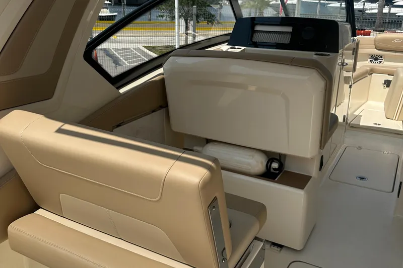  Yacht Photos Pics 2022 Scout 277 Dorado boat interior with beige seating and helm station.