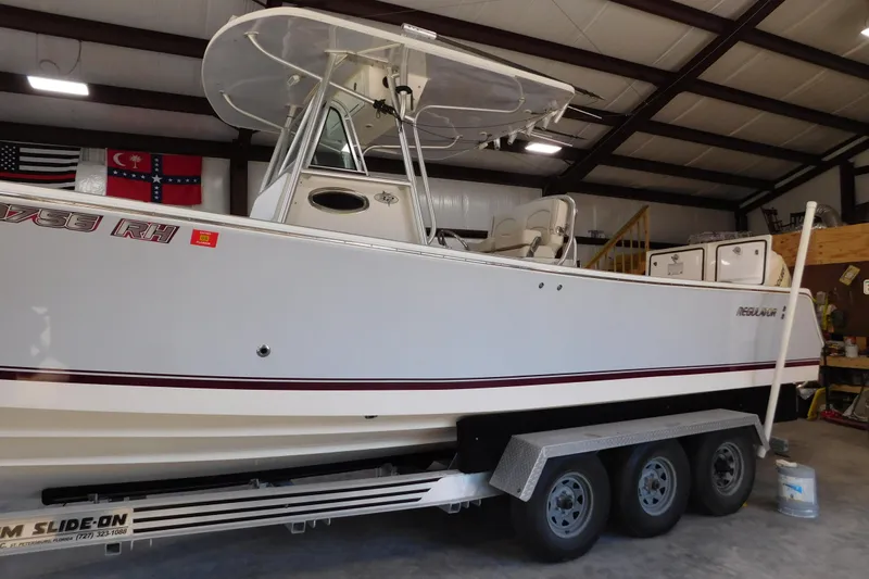  Yacht Photos Pics 2003 Regulator 32 Center Console boat on trailer in indoor storage facility.
