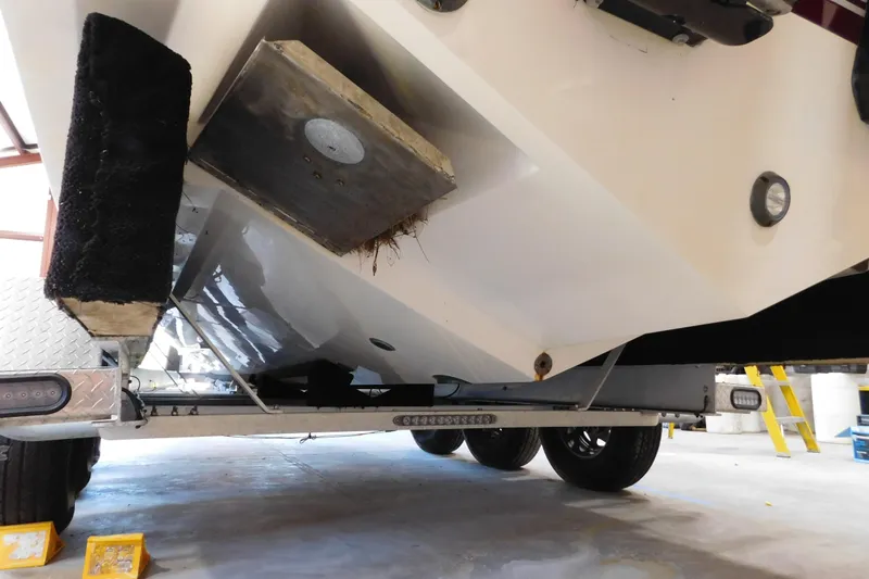  Yacht Photos Pics 2003 Regulator 32 Center Console boat on trailer, underside view in garage setting.