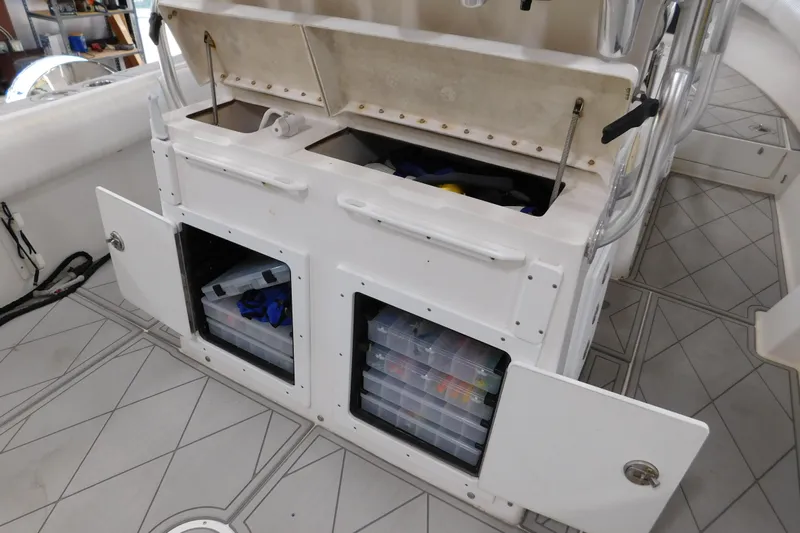  Yacht Photos Pics 2003 Regulator 32 Center Console storage compartments with organized fishing gear.