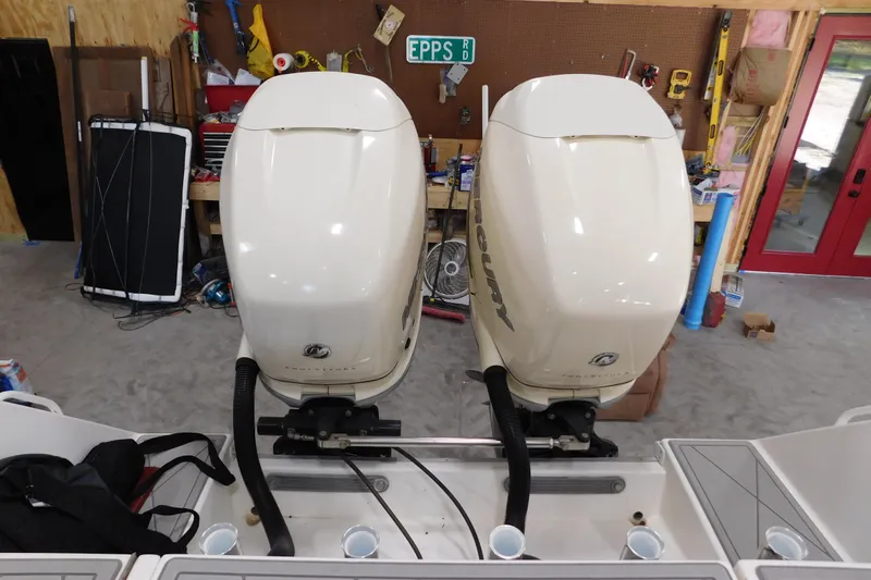  Yacht Photos Pics Twin Mercury outboard engines on a 2003 Regulator 32 Center Console boat in a workshop.