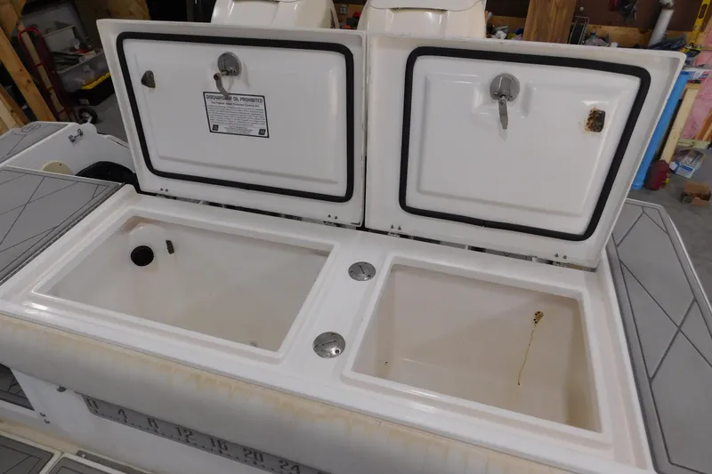  Yacht Photos Pics 2003 Regulator 32 Center Console storage compartments with open lids in a garage setting.