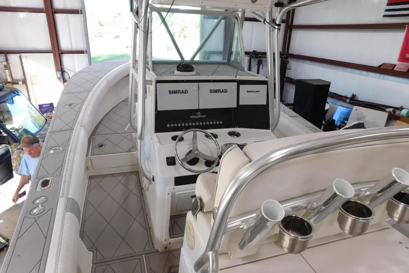  Yacht Photos Pics 2003 Regulator 32 Center Console boat interior with Simrad electronics and rod holders.