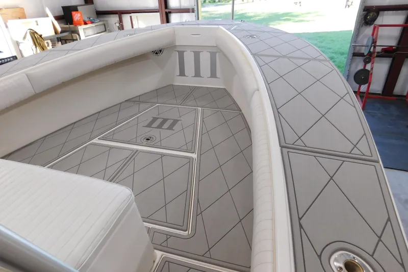  Yacht Photos Pics 2003 Regulator 32 Center Console boat interior with cushioned seating and diamond-patterned flooring.