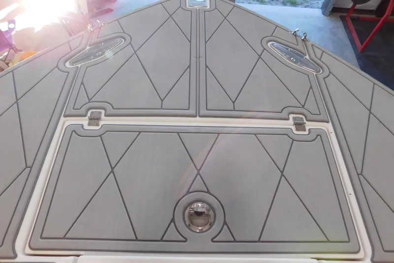  Yacht Photos Pics 2003 Regulator 32 Center Console boat deck with geometric pattern and stainless steel fixtures.