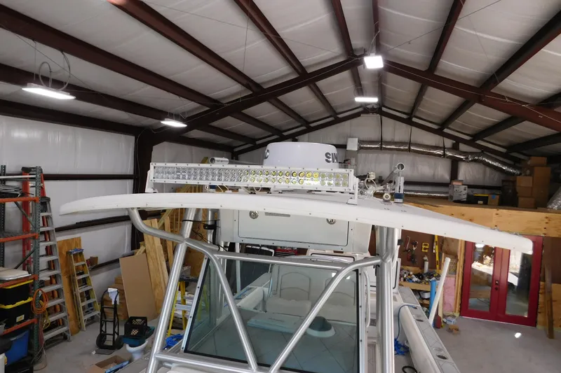  Yacht Photos Pics 2003 Regulator 32 Center Console boat in a workshop with LED light bar installation.