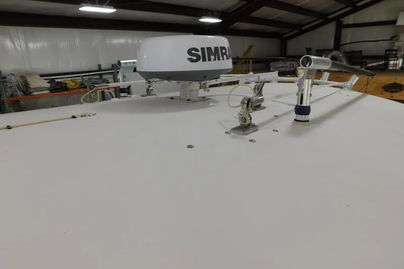  Yacht Photos Pics 2003 Regulator 32 Center Console boat with Simrad radar in a storage facility.