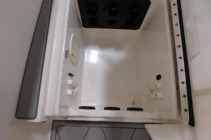  Yacht Photos Pics 2003 Regulator 32 Center Console storage compartment interior view.