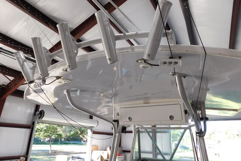  Yacht Photos Pics 2003 Regulator 32 Center Console boat with rod holders in a storage facility.