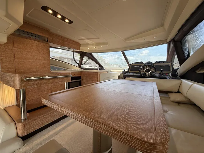  Yacht Photos Pics Luxurious interior of a 2016 Azimut 54 yacht with modern wood finishes and spacious seating.