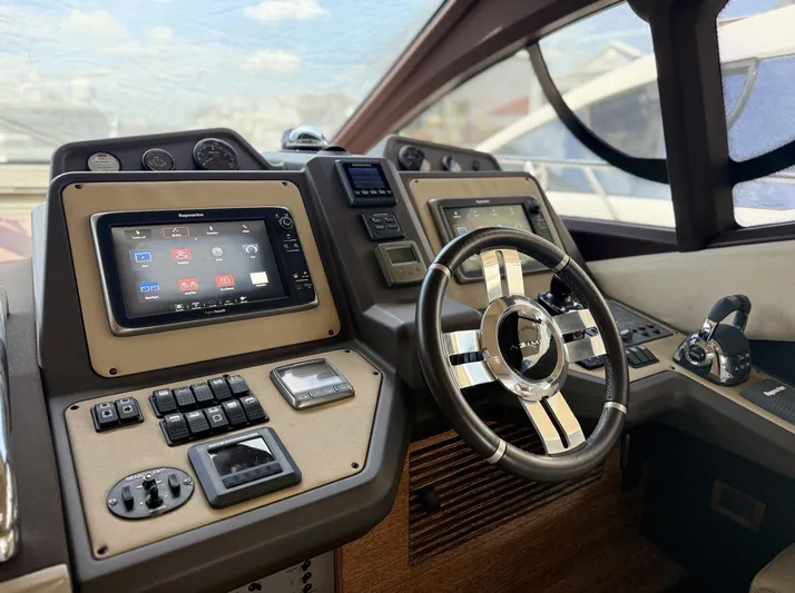  Yacht Photos Pics 2016 Azimut 54 yacht helm with modern navigation controls and sleek steering wheel.