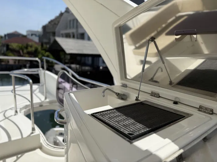  Yacht Photos Pics 2016 Azimut 54 yacht deck with open grill, overlooking waterfront homes.