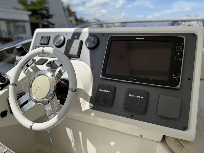  Yacht Photos Pics Cockpit of 2016 Azimut 54 yacht featuring modern steering and navigation controls.