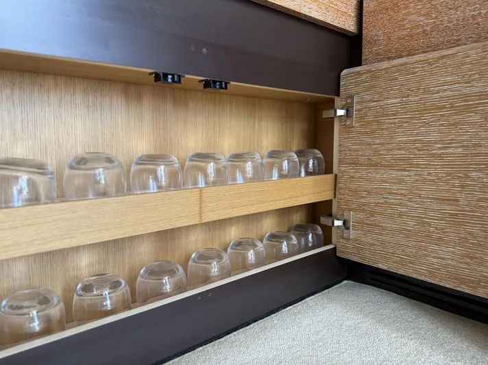  Yacht Photos Pics Cabinet with glass storage in 2016 Azimut 54 yacht interior.