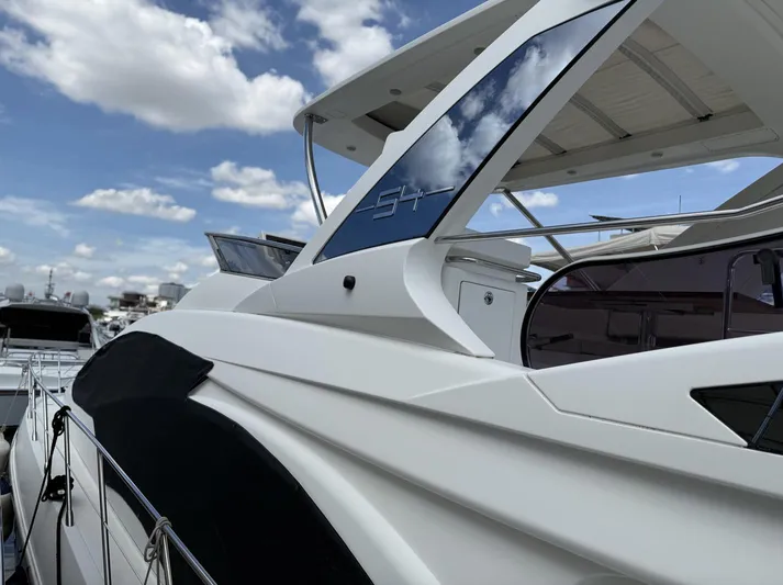  Yacht Photos Pics 2016 Azimut 54 yacht with sleek design under a partly cloudy sky.