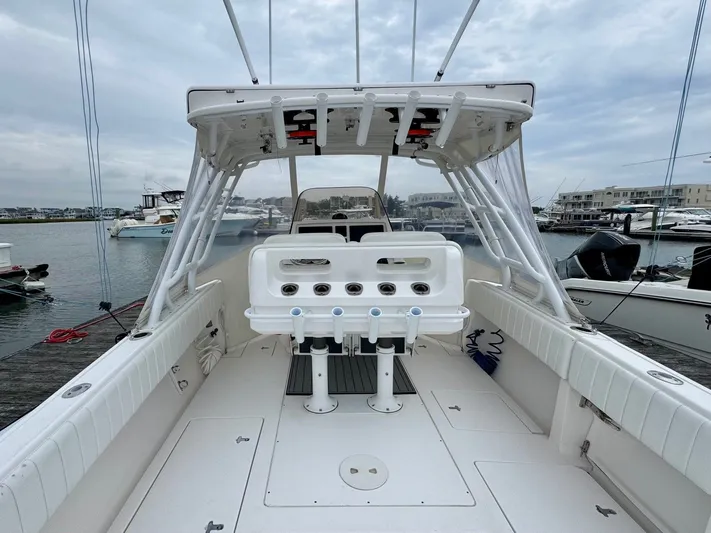  Yacht Photos Pics 2016 Intrepid 327 Center Console boat docked at marina, featuring spacious deck and seating.