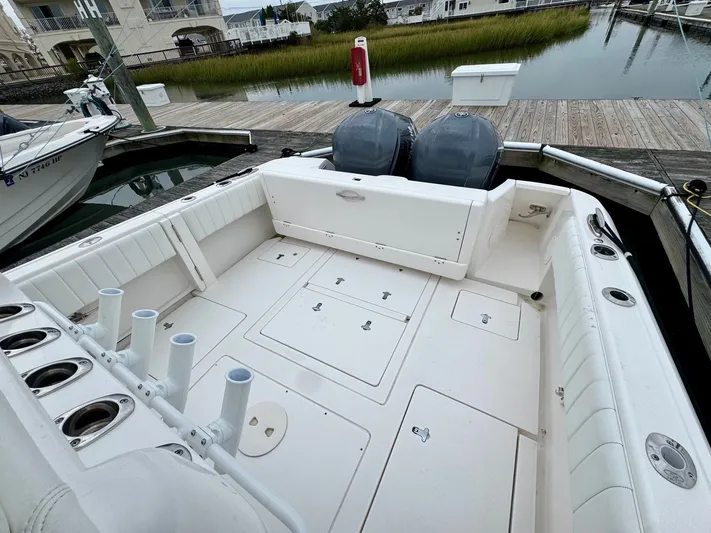  Yacht Photos Pics 2016 Intrepid 327 Center Console boat docked, featuring spacious deck and dual outboard engines.
