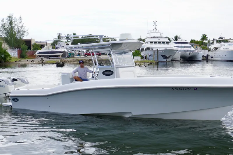  Yacht Photos Pics 2019 Dusky 33 boat on water, docked near luxury yachts.