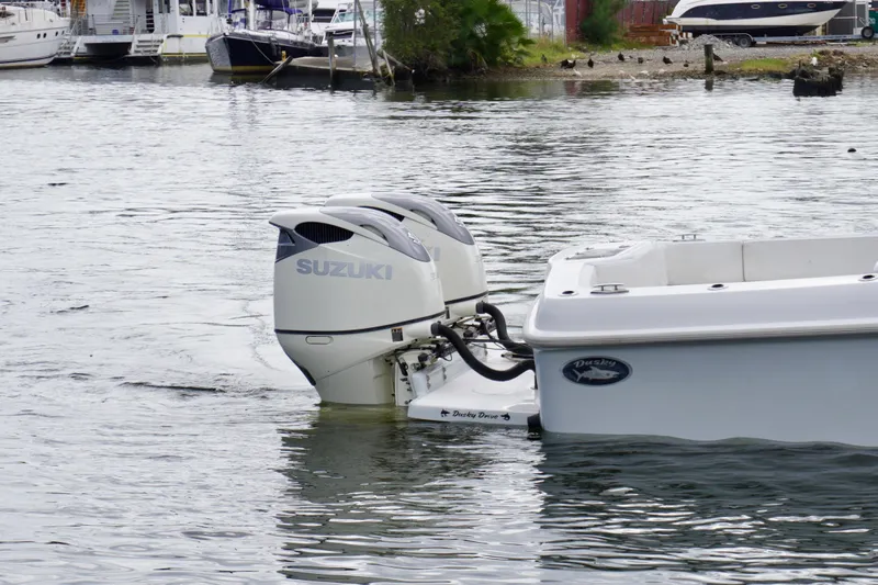  Yacht Photos Pics 2019 Dusky 33 boat with Suzuki outboard engines on calm water.