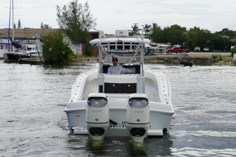  Yacht Photos Pics 2019 Dusky 33 boat with dual Suzuki 350 engines navigating a marina.