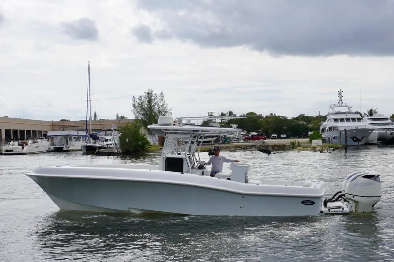  Yacht Photos Pics 2019 Dusky 33 boat cruising in a marina with yachts in the background.