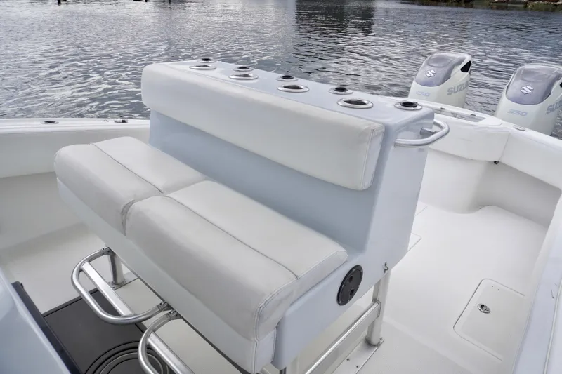  Yacht Photos Pics 2019 Dusky 33 boat interior with cushioned seating and Suzuki outboard motors.