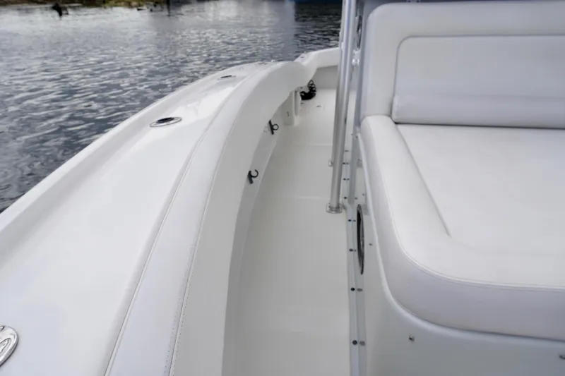  Yacht Photos Pics 2019 Dusky 33 boat interior with white seating and sleek design on calm water.