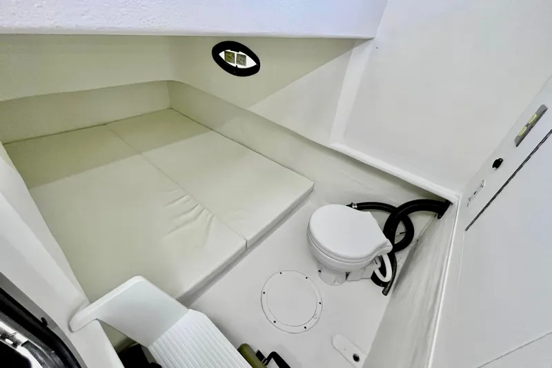  Yacht Photos Pics 2019 Dusky 33 boat interior with bed and toilet, featuring compact and efficient design.