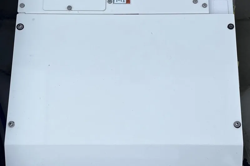  Yacht Photos Pics White panel on a 2019 Dusky 33 boat, featuring screws and a small label.