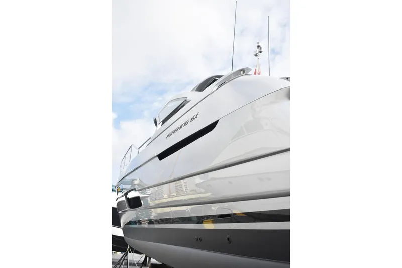 Rivo Co Rivo Yacht Photos Pics 2019 Pershing 5x yacht, sleek design, docked under cloudy sky.