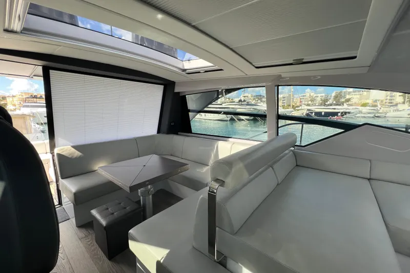 Rivo Co Rivo Yacht Photos Pics Luxurious interior of 2019 Pershing 5x yacht with modern seating and marina view.
