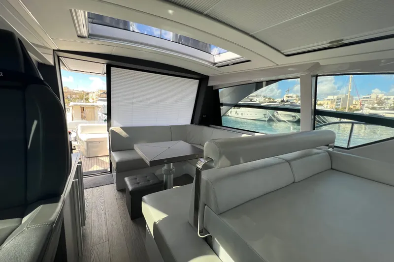 Rivo Co Rivo Yacht Photos Pics Interior of 2019 Pershing 5x yacht with modern seating and marina view.