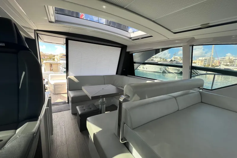 Rivo Co Rivo Yacht Photos Pics Luxurious interior of 2019 Pershing 5x yacht with modern seating and marina view.