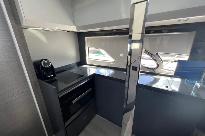 Rivo Co Rivo Yacht Photos Pics Modern kitchen interior of 2019 Pershing 5x yacht with sleek design and appliances.