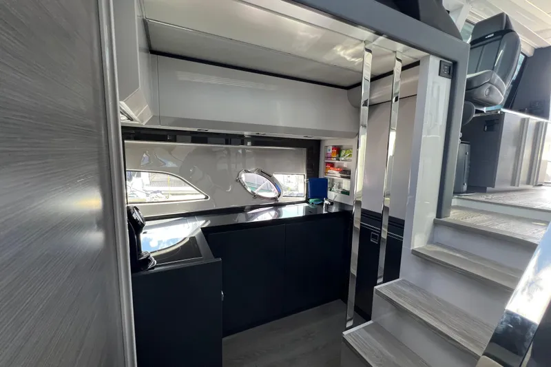 Rivo Co Rivo Yacht Photos Pics Modern interior of 2019 Pershing 5x yacht with sleek kitchen and stairs.