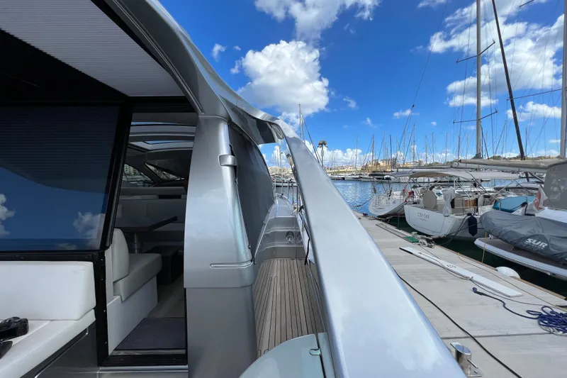 Rivo Co Rivo Yacht Photos Pics 2019 Pershing 5x yacht docked at marina under blue sky with clouds.