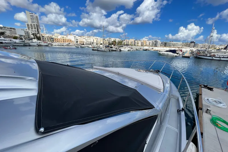 Rivo Co Rivo Yacht Photos Pics 2019 Pershing 5x yacht docked in a marina under a partly cloudy sky.