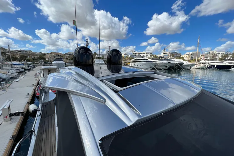 Rivo Co Rivo Yacht Photos Pics 2019 Pershing 5x yacht docked at marina under blue sky with clouds.